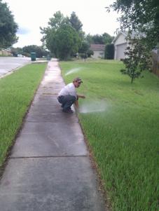 oneof our Channelview sprinkler repair techs is inspecting the sprinkler coverage